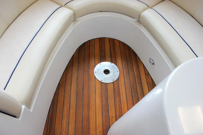 Slide: The Image of 2004 Chris-Craft 28 LAUNCH boat interior with teak flooring and cushioned seating. - 30