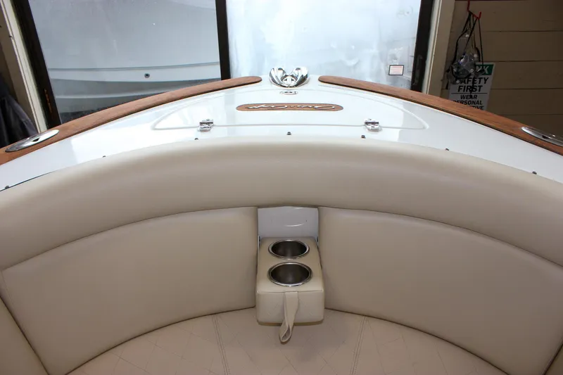 Slide: The Image of 2004 Chris-Craft 28 Launch boat interior with white seating and cup holders. - 31