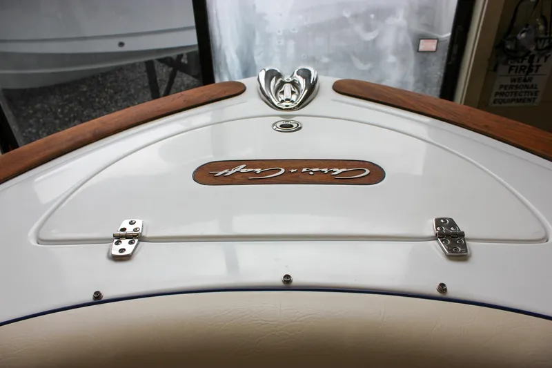 Slide: The Image of 2004 Chris-Craft 28 LAUNCH boat deck with wood accents and metal fittings. - 32