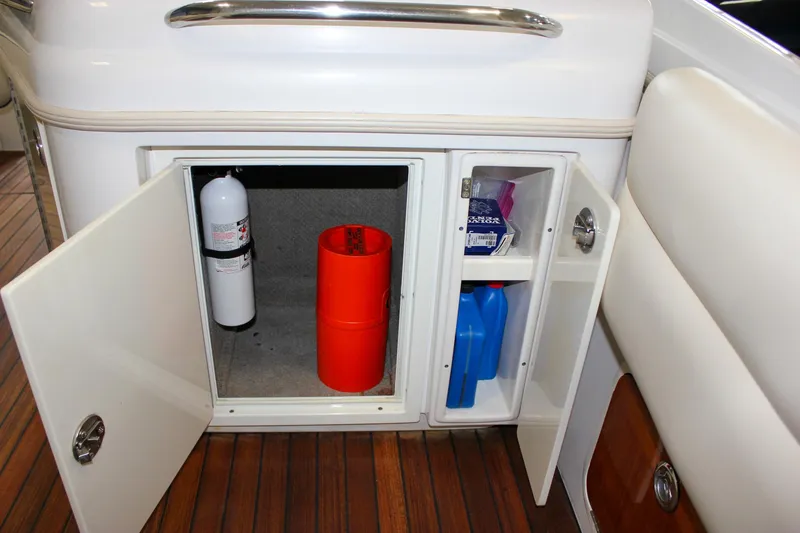 Slide: The Image of Storage compartment on 2004 Chris-Craft 28 Launch boat with fire extinguisher and supplies. - 33