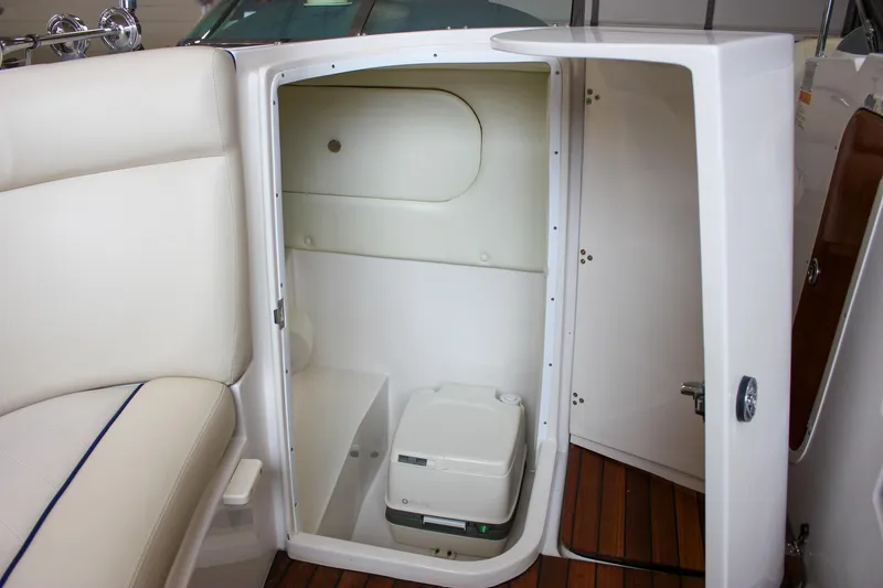 Slide: The Image of 2004 Chris-Craft 28 LAUNCH boat interior with compact toilet and seating area. - 37