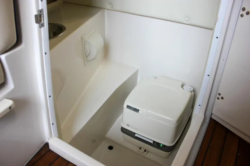 Slide: The Image of 2004 Chris-Craft 28 Launch boat interior with compact marine toilet and sink. - 38
