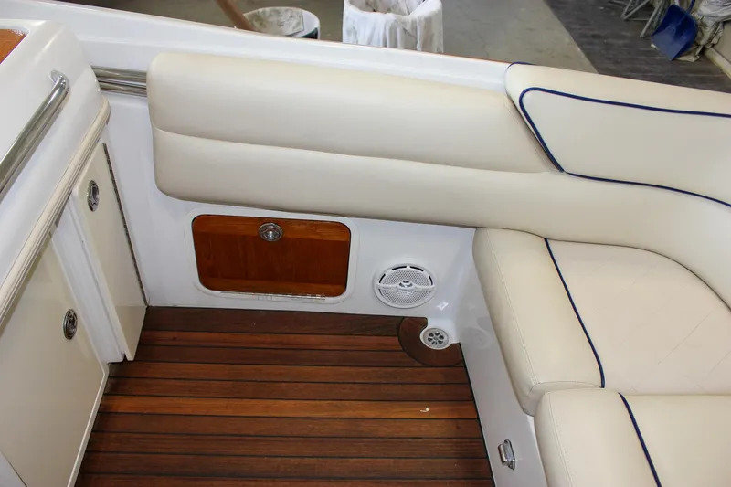 Slide: The Image of Interior of 2004 Chris-Craft 28 Launch with white seating and wooden flooring. - 44