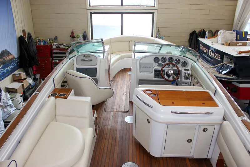 Slide: The Image of 2004 Chris-Craft 28 Launch boat interior with wooden flooring and white seating. - 45