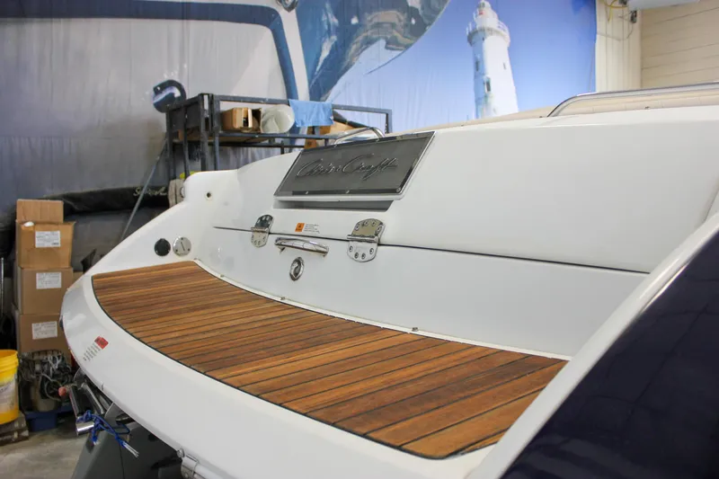 Slide: The Image of 2004 Chris-Craft 28 Launch boat with wooden deck in indoor storage. - 5