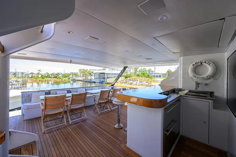 Slide: The Image of Spacious deck of 1997 Broward 108 Raised Pilothouse yacht with outdoor seating and bar area. - 11
