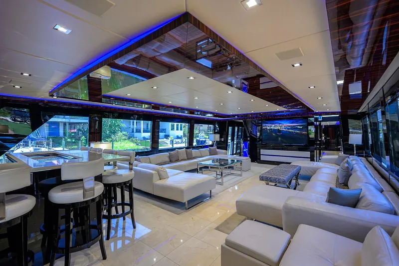 Slide: The Image of Luxurious interior of 1997 Broward 108 Raised Pilothouse yacht with modern white seating. - 13
