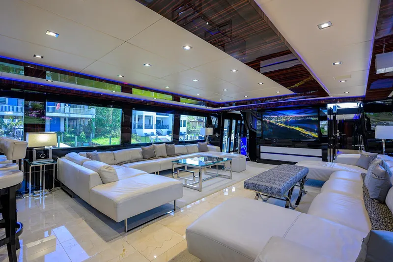 Slide: The Image of Luxurious interior of 1997 Broward 108 Raised Pilothouse yacht with modern white seating. - 14