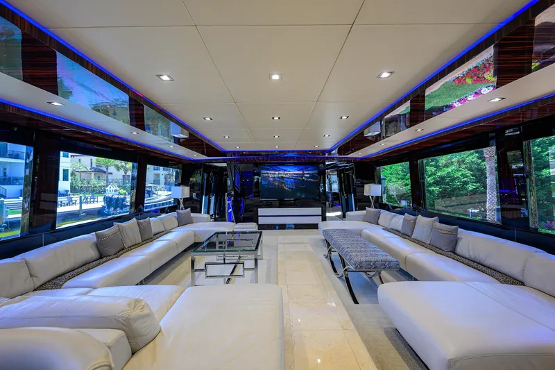 Slide: The Image of Luxurious interior of 1997 Broward 108 Raised Pilothouse yacht with modern seating and large windows. - 15