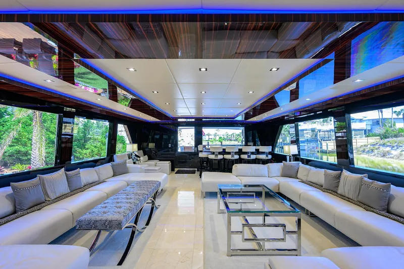 Slide: The Image of Luxurious interior of 1997 Broward 108 Raised Pilothouse yacht with modern seating and glass tables. - 18