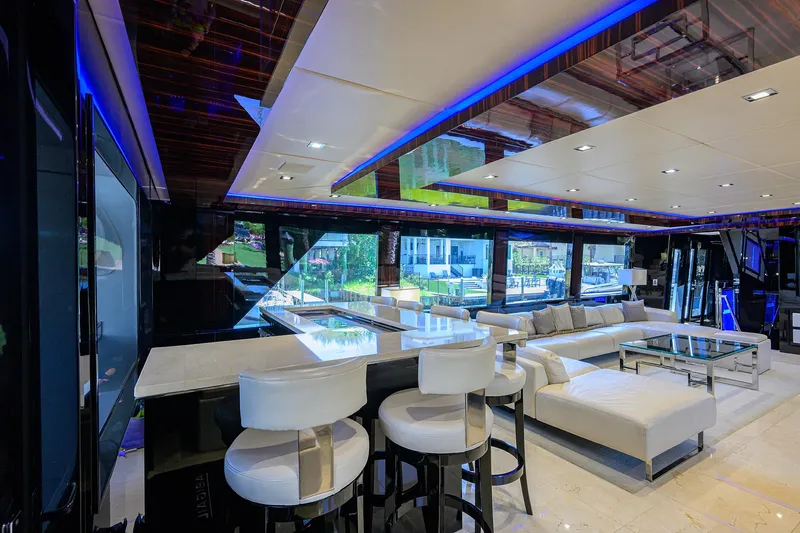 Slide: The Image of Luxurious interior of 1997 Broward 108 Raised Pilothouse yacht with modern seating and ambient lighting. - 24