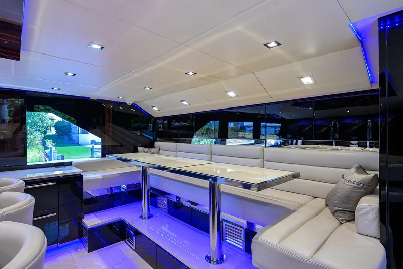 Slide: The Image of Luxurious interior of 1997 Broward 108 Raised Pilothouse yacht with modern seating and ambient lighting. - 29