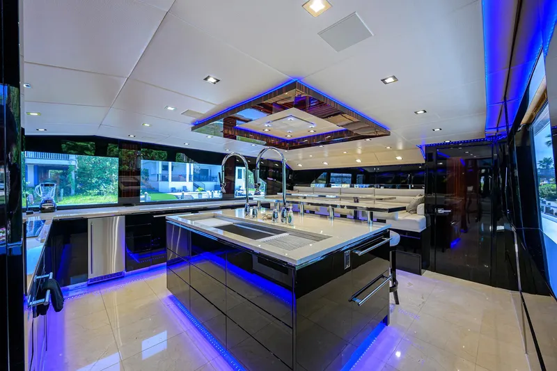 Slide: The Image of Luxurious kitchen interior of 1997 Broward 108 Raised Pilothouse yacht with modern lighting. - 30
