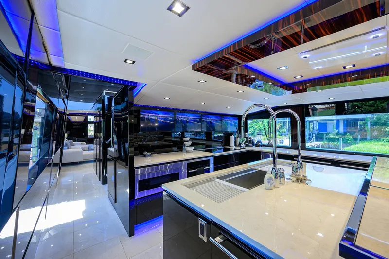 Slide: The Image of Luxurious kitchen interior of 1997 Broward 108 Raised Pilothouse yacht with modern fixtures. - 32