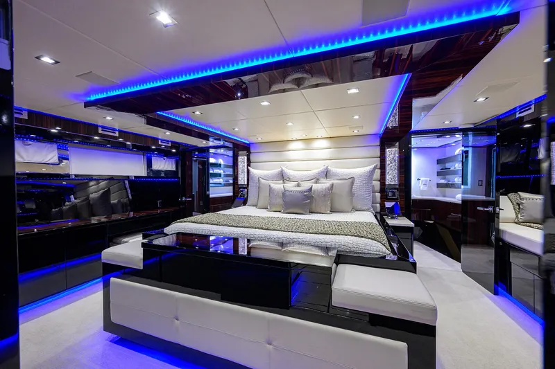 Slide: The Image of Luxurious bedroom interior of 1997 Broward 108 Raised Pilothouse yacht with blue LED lighting. - 45