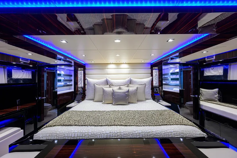 Slide: The Image of Luxurious bedroom interior of 1997 Broward 108 Raised Pilothouse yacht with blue LED lighting. - 46