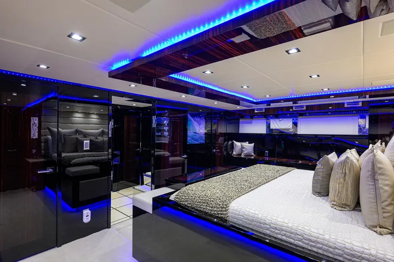 Slide: The Image of Luxurious bedroom interior of 1997 Broward 108 Raised Pilothouse yacht with modern lighting. - 48