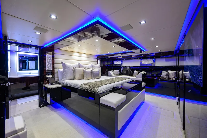 Slide: The Image of Luxurious master bedroom on a 1997 Broward 108 Raised Pilothouse yacht with modern LED lighting. - 49