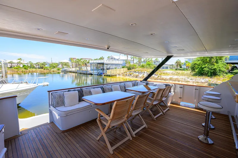 Slide: The Image of Luxury outdoor seating area on a 1997 Broward 108 Raised Pilothouse yacht. - 5