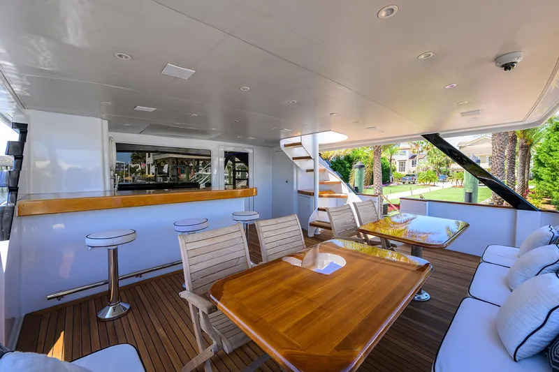 Slide: The Image of Spacious deck of 1997 Broward 108 Raised Pilothouse yacht with seating and bar area. - 8