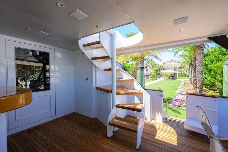Slide: The Image of Interior of 1997 Broward 108 Raised Pilothouse yacht with wooden stairs and deck. - 9