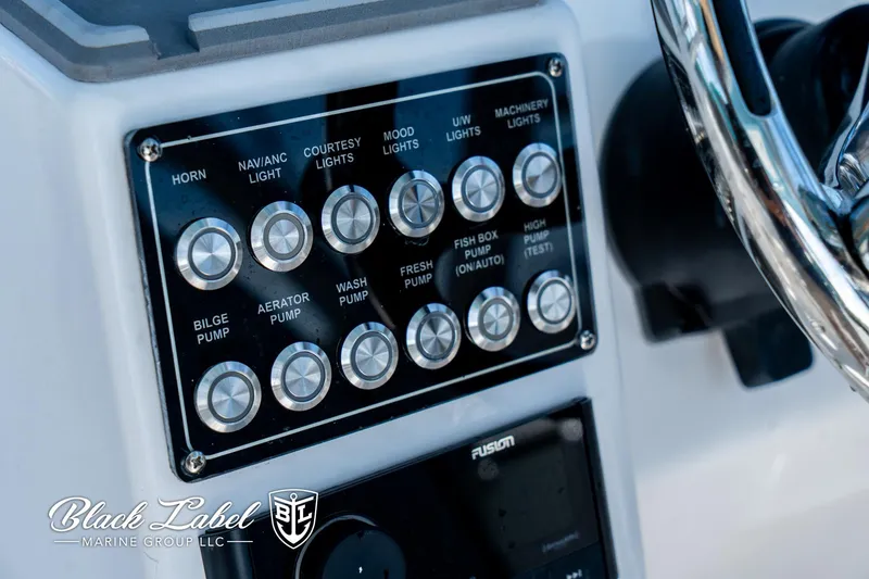 Slide: The Image of Control panel of 2024 Sea Fox 288 Traveler Dual Console boat with labeled switches. - 19