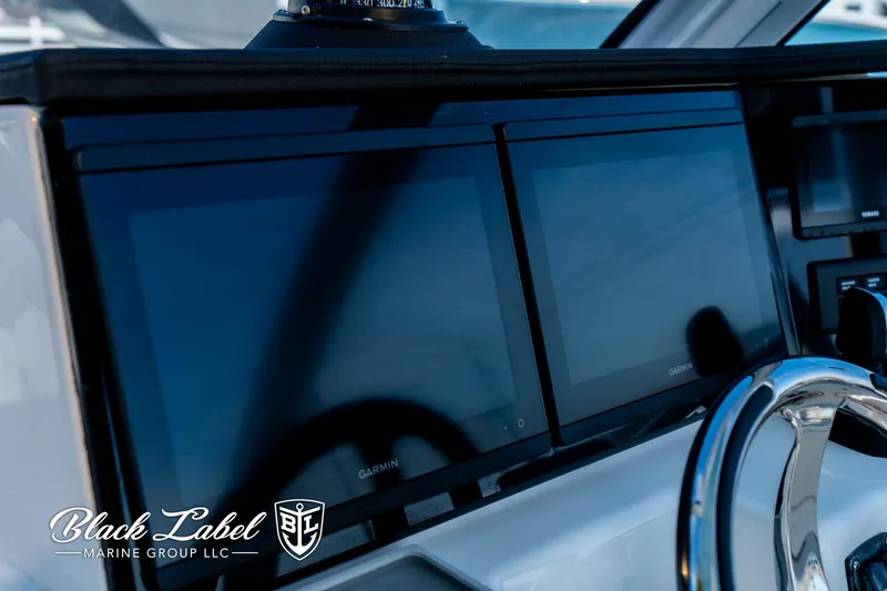 Slide: The Image of 2024 Sea Fox 288 Traveler Dual Console dashboard with Garmin displays and steering wheel. - 20