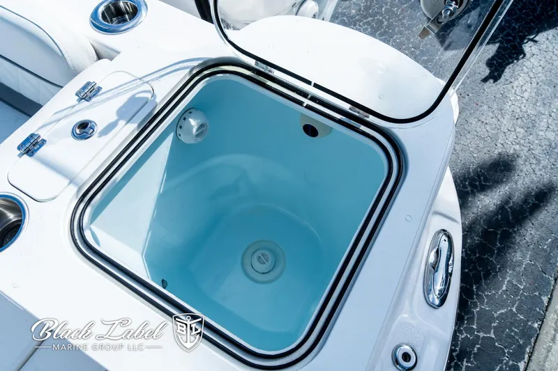 Slide: The Image of 2024 Sea Fox 288 Traveler Dual Console livewell, open lid, white interior, marine equipment. - 33