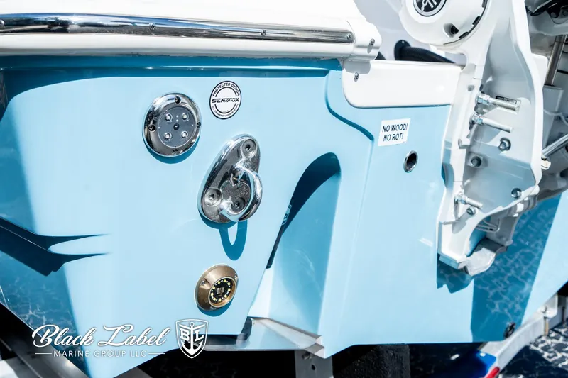 Slide: The Image of 2024 Sea Fox 288 Traveler Dual Console boat, featuring sleek blue exterior and marine hardware. - 42