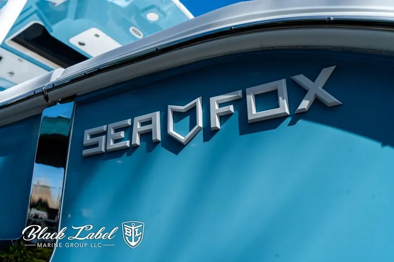 Slide: The Image of 2024 Sea Fox 288 Traveler Dual Console boat with blue hull and logo. - 43