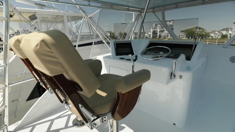 Slide: The Image of Captain's chair and helm of a 2003 Custom Carolina Dean Johnson boat. - 36