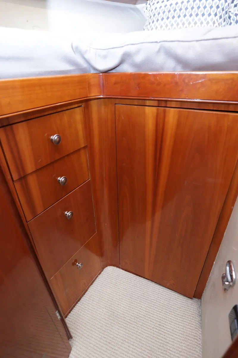 Slide: The Image of 2003 Custom Carolina Dean Johnson boat interior with wooden cabinetry and drawers. - 45