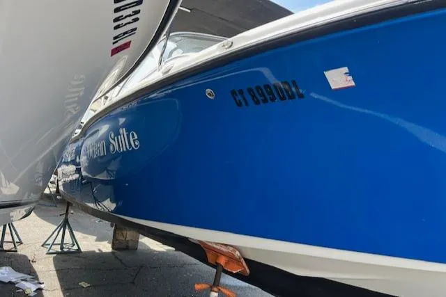 Slide: The Image of 2020 Key West 239 DFS boat in blue, docked and supported by stands. - 3