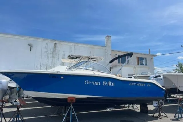 Slide: The Image of 2020 Key West 239 DFS boat named Ocean Suite on stands in a marina. - 4