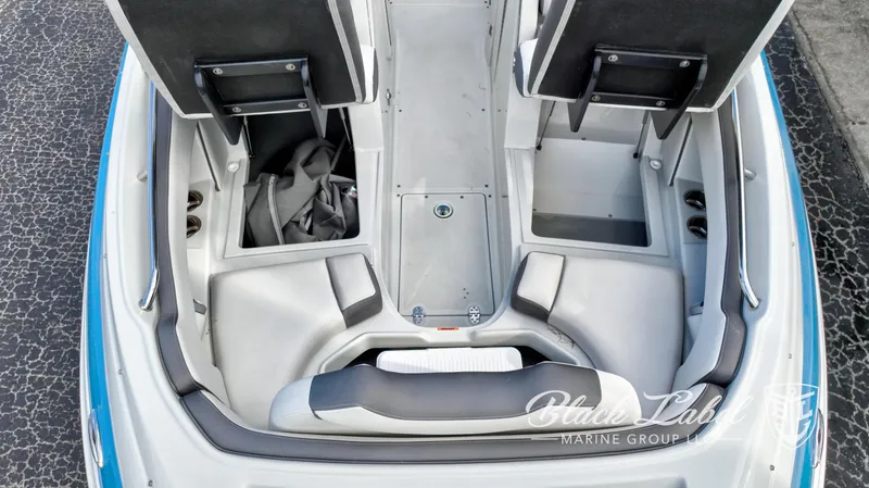 Slide: The Image of 2024 Crownline E260 XS boat interior with open storage compartments and seating. - 10
