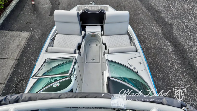 Slide: The Image of 2024 Crownline E260 XS boat interior with seating and windshield, Black Label Marine Group logo. - 11