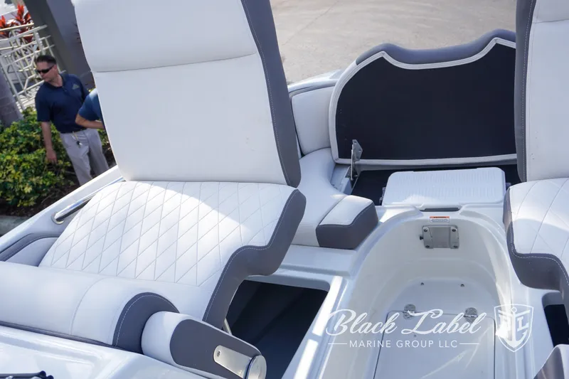 Slide: The Image of 2024 Crownline E260 XS boat interior with white and gray seating, Black Label Marine Group logo. - 14