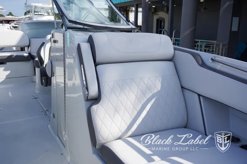 Slide: The Image of 2024 Crownline E260 XS boat interior with luxurious seating, showcased by Black Label Marine Group. - 17