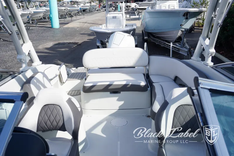Slide: The Image of 2024 Crownline E260 XS boat interior with plush seating, showcased by Black Label Marine Group. - 18