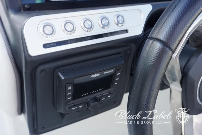 Slide: The Image of 2024 Crownline E260 XS dashboard with control panel and steering wheel. - 22