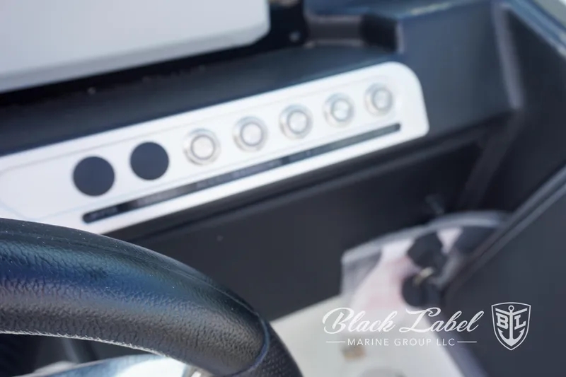 Slide: The Image of 2024 Crownline E260 XS dashboard with control panel, Black Label Marine Group logo. - 23
