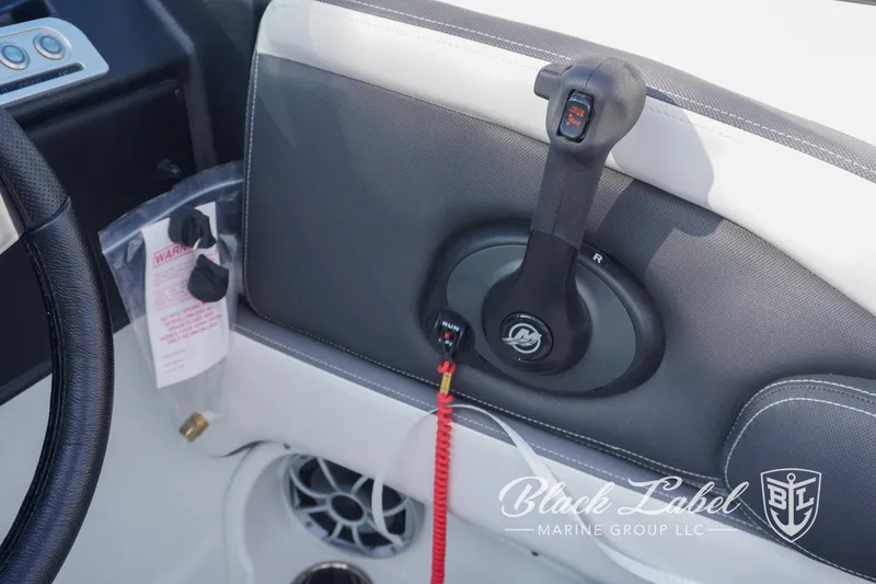 Slide: The Image of 2024 Crownline E260 XS boat control panel with safety features and branding. - 24