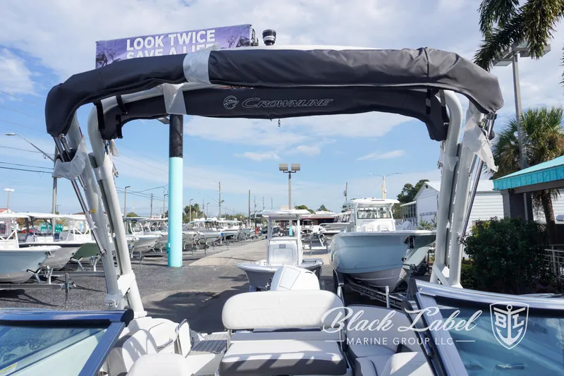 Slide: The Image of 2024 Crownline E260 XS boat with canopy at Black Label Marine Group. - 26
