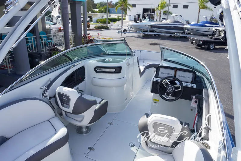 Slide: The Image of 2024 Crownline E260 XS boat interior with modern seating and dashboard. - 28