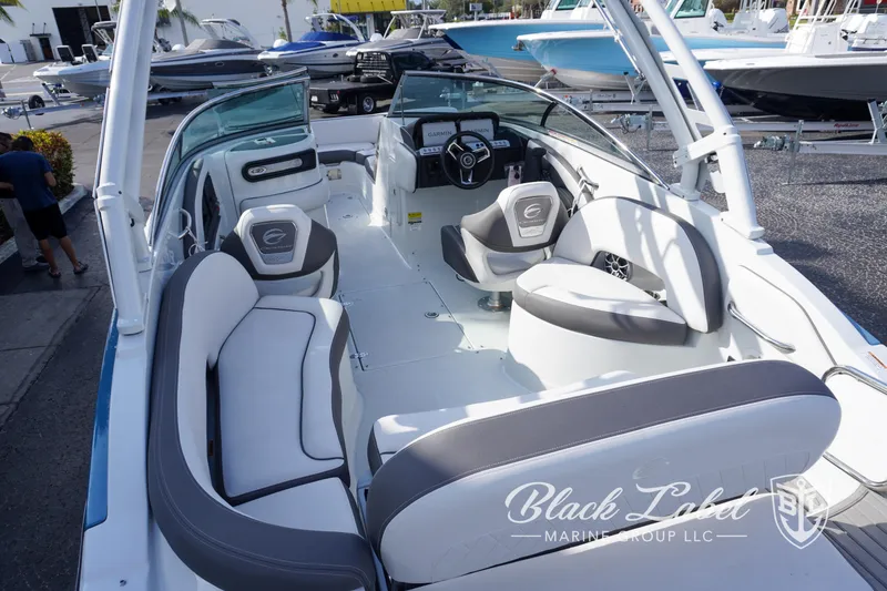 Slide: The Image of 2024 Crownline E260 XS boat interior with modern seating and steering wheel. - 29
