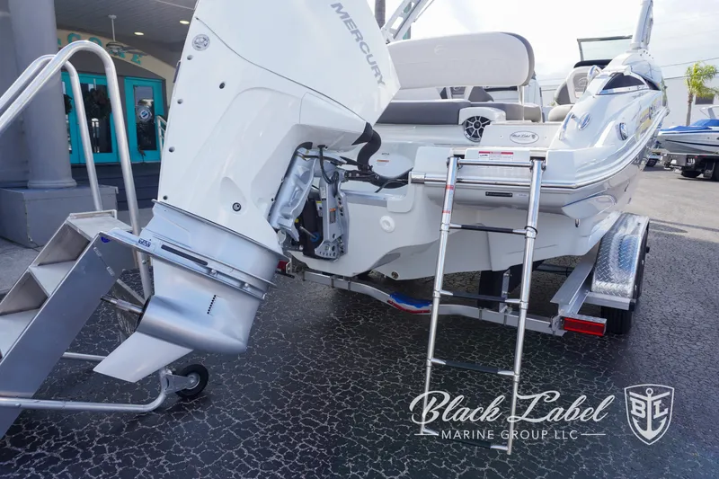 Slide: The Image of 2024 Crownline E260 XS boat with Mercury outboard motor and boarding ladder. - 30