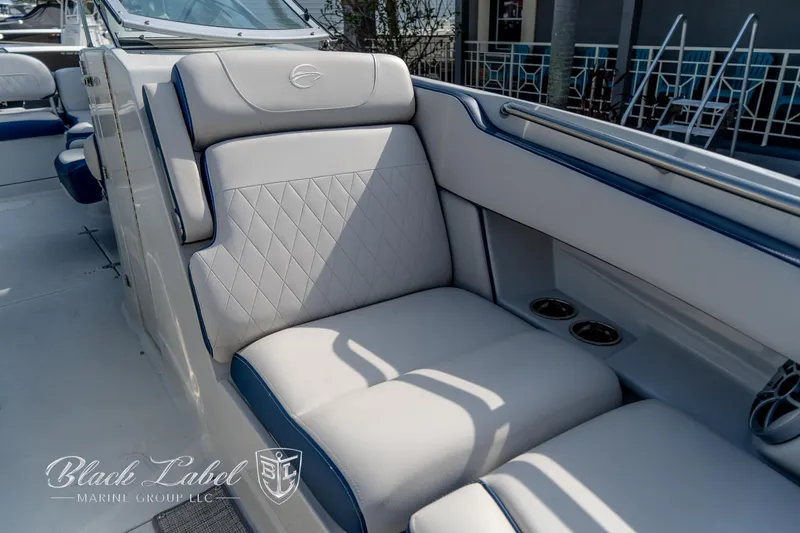 Slide: The Image of 2024 Crownline E260 XS boat interior with luxurious seating and cup holders. - 10