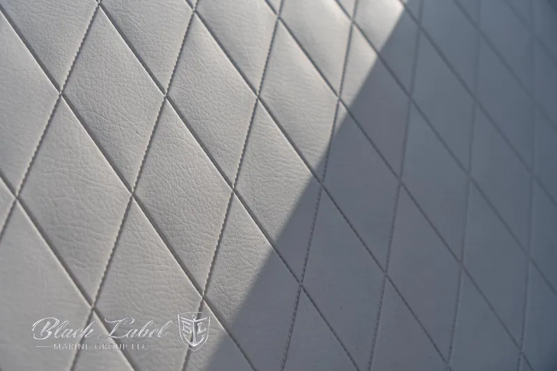 Slide: The Image of Diamond-stitched upholstery detail on 2024 Crownline E260 XS boat interior. - 14