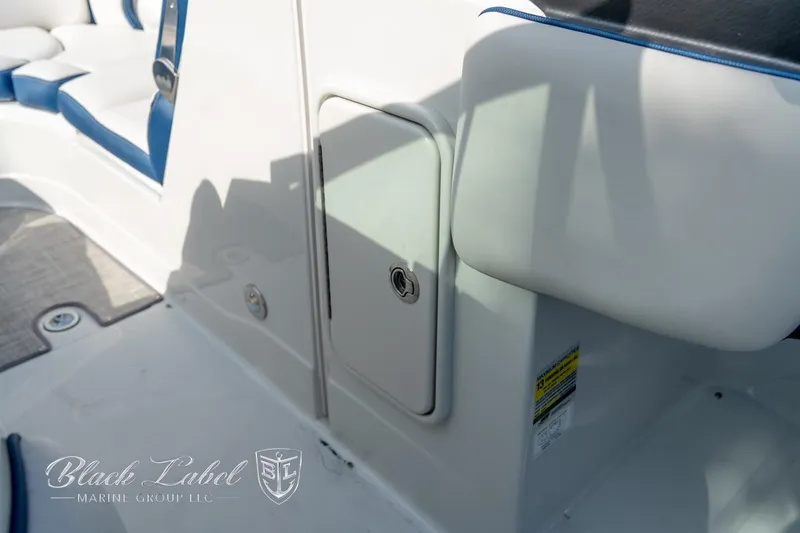 Slide: The Image of 2024 Crownline E260 XS boat interior with white and blue seating. - 15