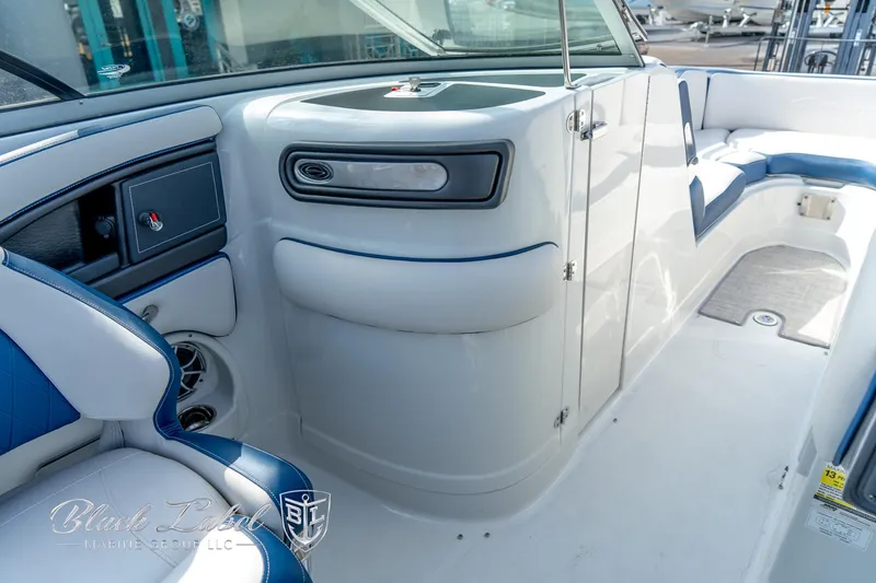 Slide: The Image of 2024 Crownline E260 XS boat interior with blue and white seating. - 17